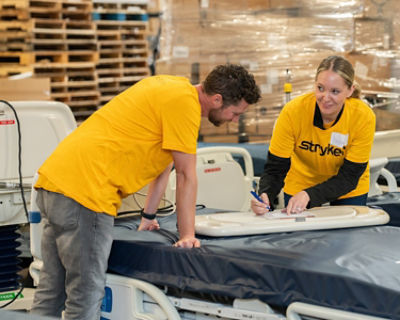 Two Stryker employees volunteer at Project C.U.R.E.'s distribution center