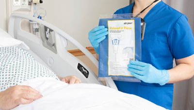 A nurse holding PrimoFit Flow up for a patient to see