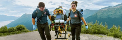 EMTs transporting patient on Power-PRO powered ambulance cot