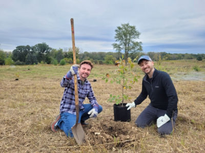 Two Stryker Sage employees planting a tree