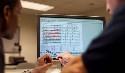 Two medical professionals review data using the CODE-STAT data review software