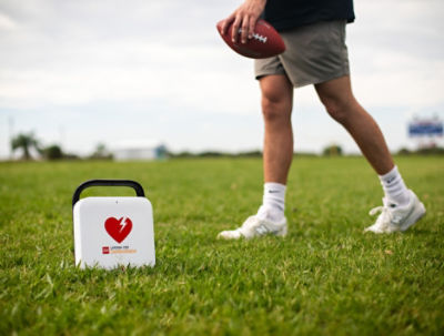 The LIFEPAK CR2 on the ground of a football field.