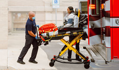 EMT loading patient into ambulance