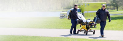 Two paramedics responding to an emergency with LIFEPAK 35, LUCAS and Power-PRO 2 in a park setting