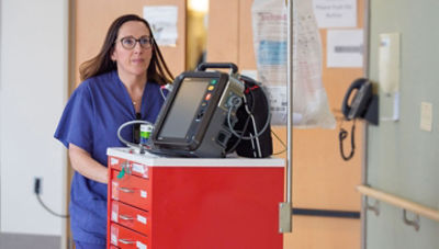 Nurse pushing crash cart LIFEPAK 35 unit on top