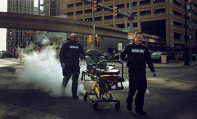 Two EMTs transport the Power-PRO 2 powered ambulance cot through the streets of Detroit