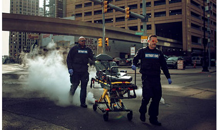 Two EMTs transport the Power-PRO 2 powered ambulance cot through the streets of Detroit