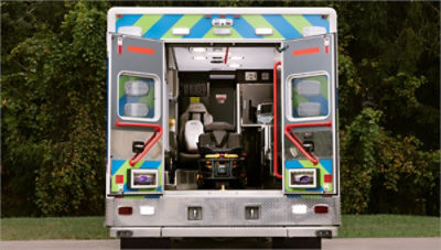 Back of an ambulance with a powered ambulance cot and LUCAS device 