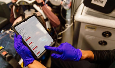 EMT and doctor reviewing LIFENET Care data in an ambulance