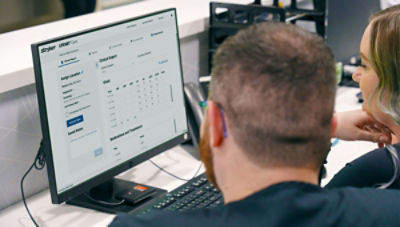 Hospital staff viewing monitor displaying LIFENET System screens