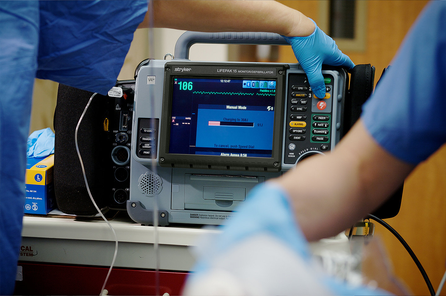 A nurse is using the LIFEPAK 15 V4+ monitor/defibrillator on a patient in the emergency room