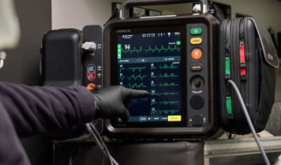 EMT using LIFEPAK 35 monitor/defibrillator touchscreen in an ambulance