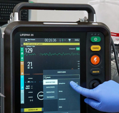 Nurse checking events on LIFEPAK 35 monitor/defibrillator touchscreen
