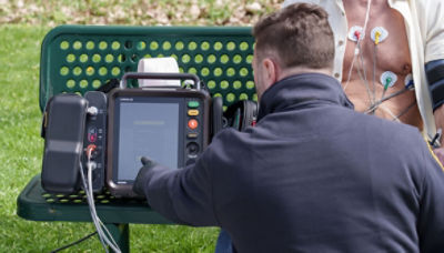 EMT monitoring patient in park with LIFEPAK 35 monitor/defibrillator