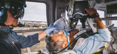 EMT performs CPR in a helicopter using an  automatic CPR machine 