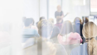 Lecturer speaking to a small room of people