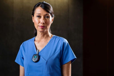 Female Critical Care Nurse wearing a Vocera Minibadge on her scrubs