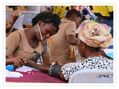 A nurse checks the blood pressure of a patient at a Project C.U.R.E. clinic