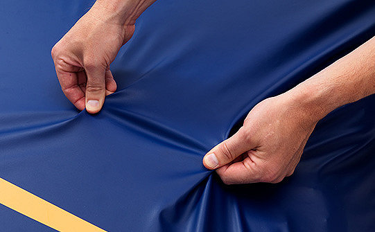 Close-up of the 4-way stretch top cover on Stryker's Eole DC support surface being stretched