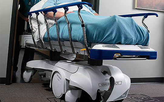 Caregiver pushing patient in Stryker's Prime stretcher