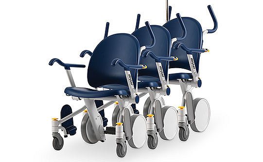 Three hospital patient transport wheelchairs nested together to save valuable space 