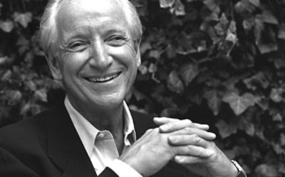 Black and white image of Michael Graves with an ivy backdrop 