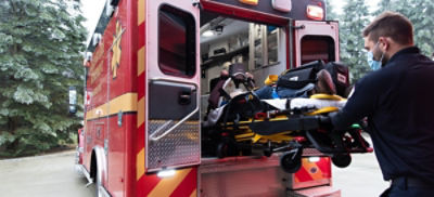EMT loads patient into ambulance using a Power-PRO 2 powered ambulance cot and a Power-LOAD powered cot fastener 