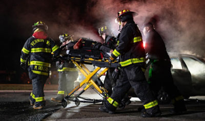 Firefighters at the scene of car crash with patient on Power-PRO 2