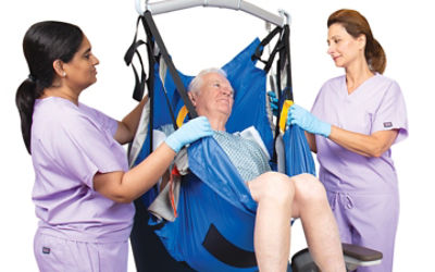 Nurses using a Sage AirTAP to move a patient 