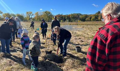 Group of people planting a tree at SEA event