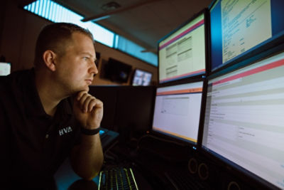 EMS provider reviewing data on multiple screens