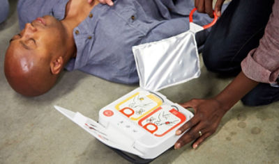 Bystander prepares LIFEPAK CR2 defibrillator for a sudden cardiac arrest victim