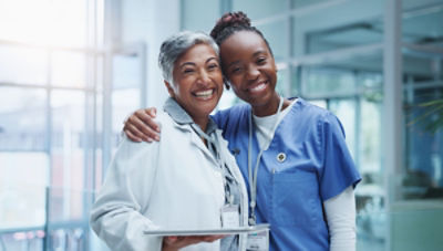 nurse with around around doctor, both smiling