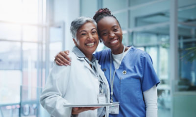 nurse with around around doctor, both smiling