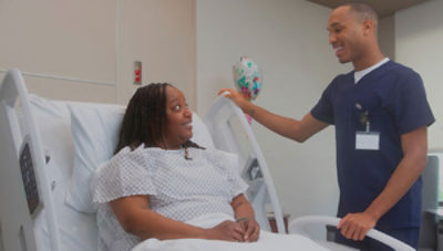 Nurse talking with patient in hospital bed