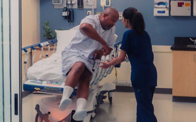 Nurse assisting patient in Prime Connect stretcher