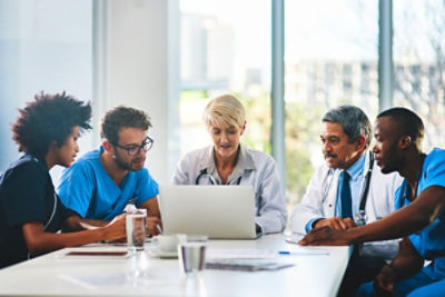 Hospital staff around table discussing Analytics