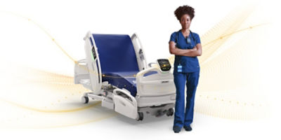 nurse standing with arms crossed in front of hospital bed