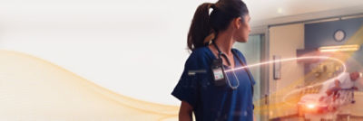 Nurse reacting to hospital bed exit alarm in patient's room 