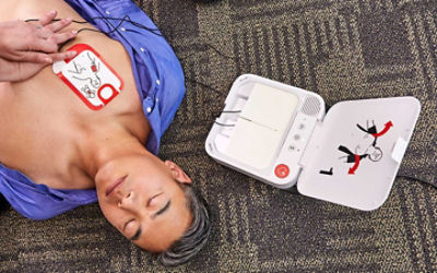 Patient lying on floor next to LIFEPAK CR2 defibrillator