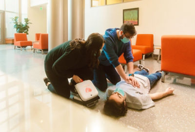 Bystander grabs LIFEPAK CR2 AED from wall cabinet in an office