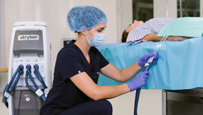 nurse pluging in Altrix temperature management system with patient lying on table