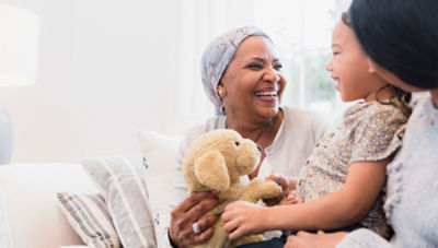 A woman beams with joy after finding relief from pain through bone tumor ablation treatment