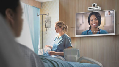 Patient interacting with clinical using Care.ai sensor, nurse in background
