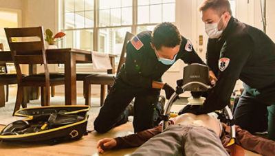 First responders using the LUCAS chest copression system on a patient 