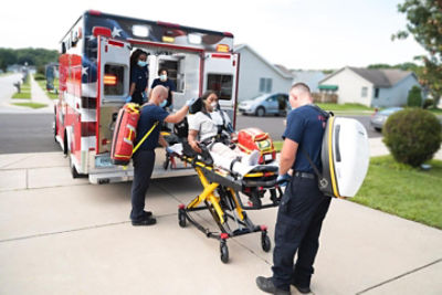 EMT loading patient on a Power-PRO 2 powered ambulance cot 
