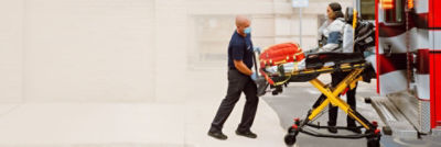 Paramedic loads patient into an ambulance on a Power-PRO powered cot 
