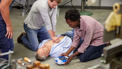 Three bystanders help a sudden cardiac arrest victim by performing CPR and preparing the HeartSince samaritan PAD 450P 