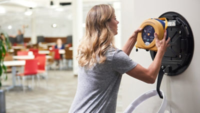 woman holding AED device