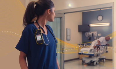 nurse looking back toward patient getting out of hospital bed